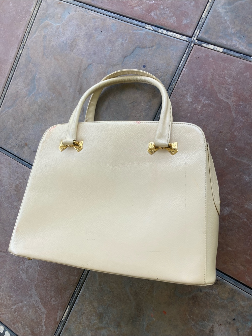 Nina Ricci 
Cream Leather Top-Handle  with Gold Bow Accents